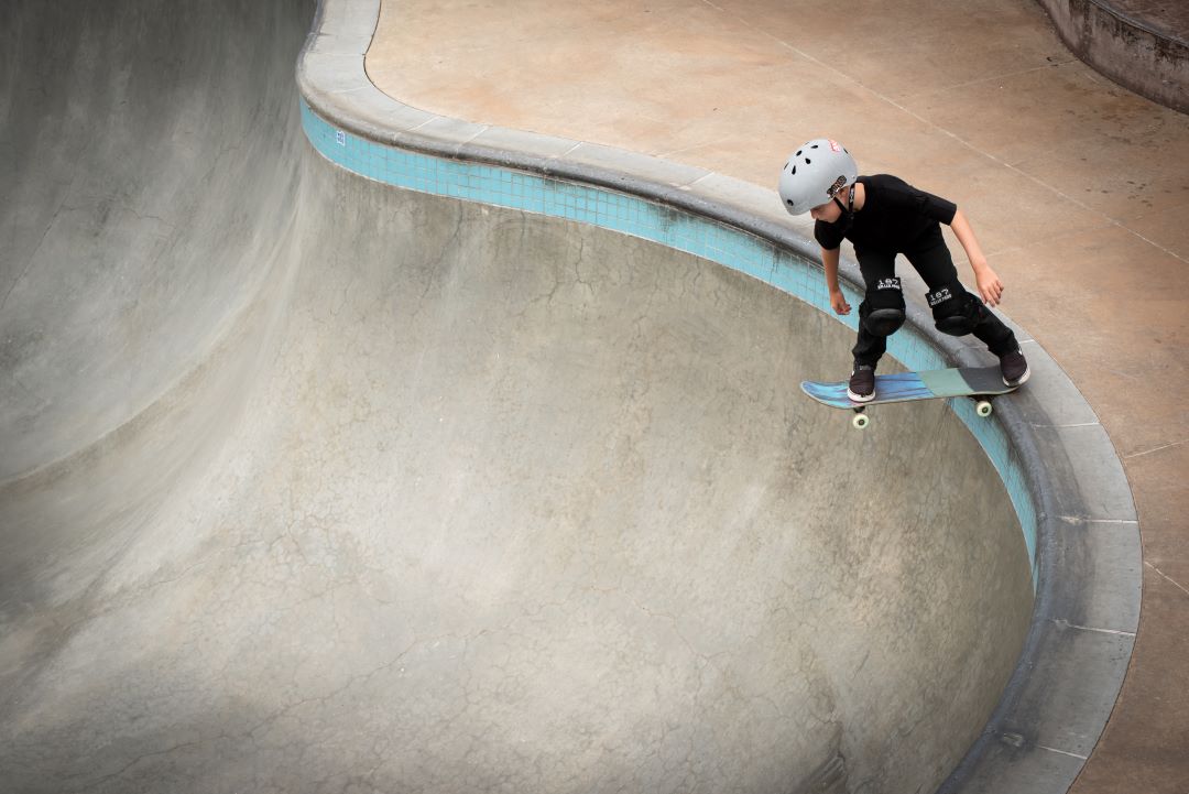 Young boy on a skateboard enjoys a skatepark built by The Skatepark Project