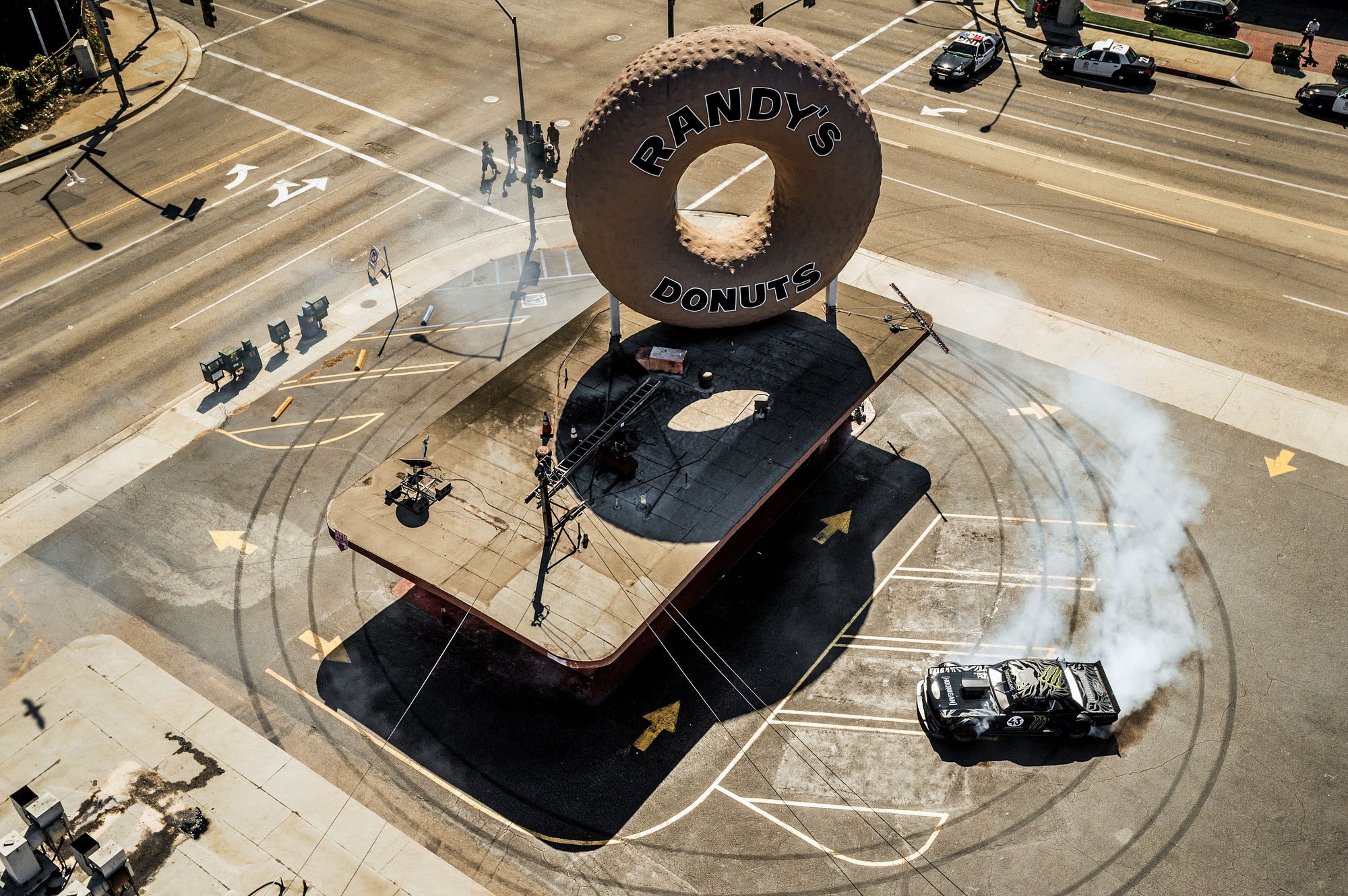 Race car does donuts around Randy's Donuts for the 43 Institute of Ken Block