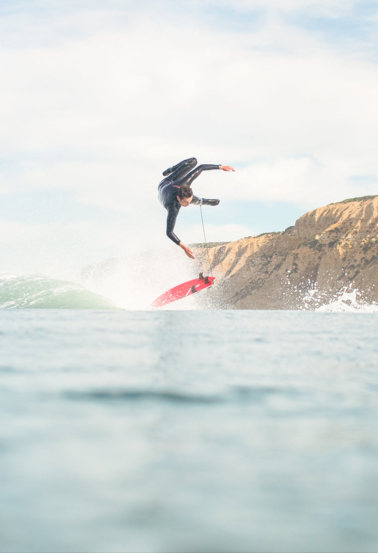 A surfer gets tossed off his board while surfing the coast.